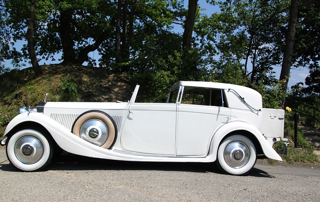 Vintage classic luxury automobile in profile, representing the early heritage and evolution of the limousine